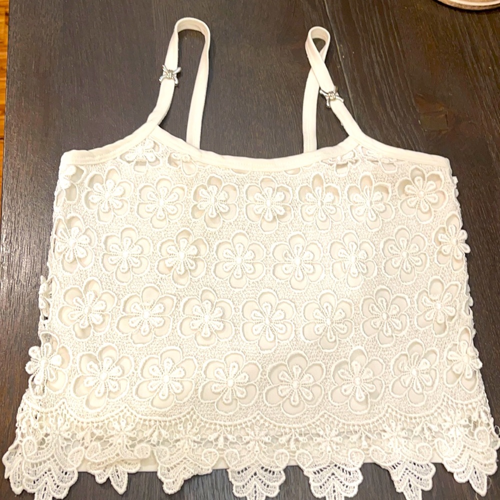 Cute lace top with accent on the straps.